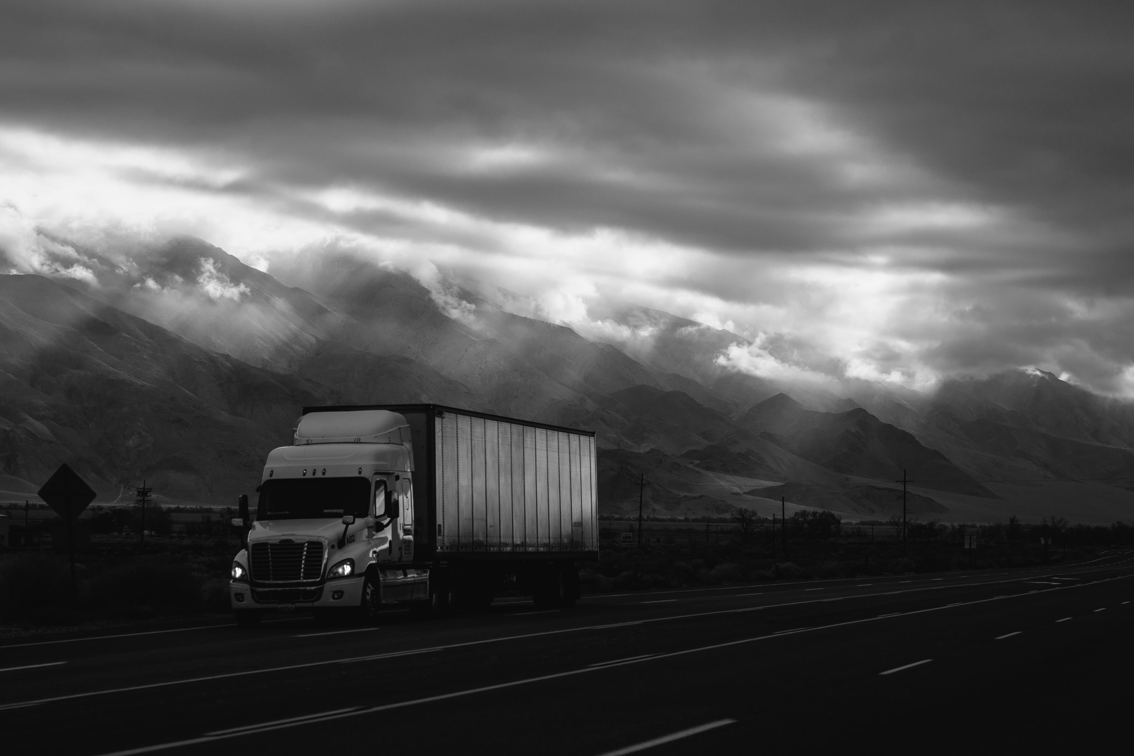Freight truck transporting goods through mountain landscape